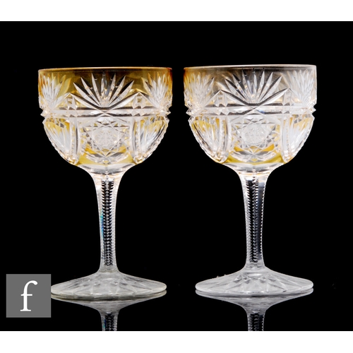 462 - A pair of early 20th Century Stourbridge amber cased and flash cut drinking glasses above slice cut ... 