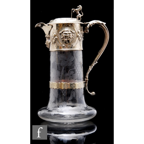 467 - A 20th Century clear crystal claret jug of low lobed and cylinder form, with engraved fruiting vine ... 