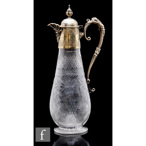 483 - A Stourbridge glass clear crystal claret jug, of ovoid form, with engraved fruiting vine decoration ... 