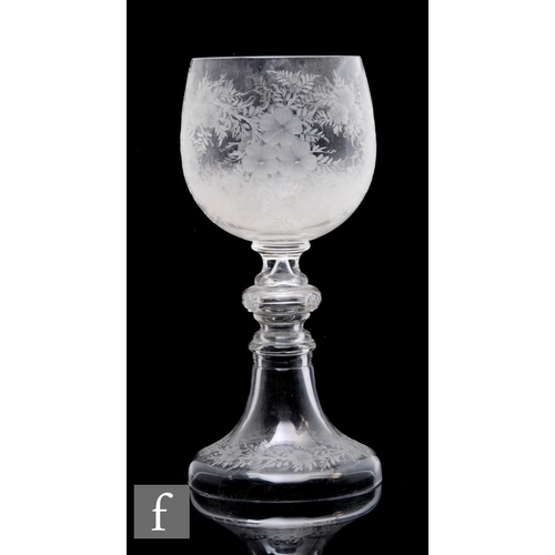 372 - A large late 19th Century continental goblet, the ovoid form bowl profusely engraved with flowers ab... 