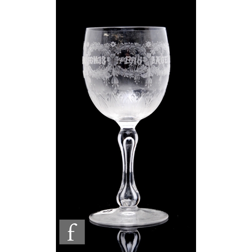 426 - An early 20th Century Stourbridge wine glass, the ovoid bowl engraved with commemorative dates in ga... 