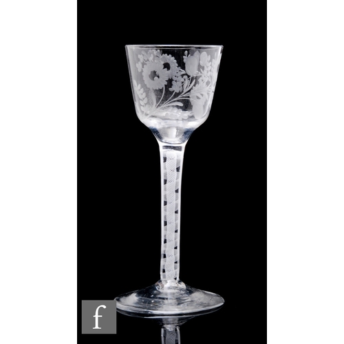 463 - An 18th Century drinking glass circa 1765, the ogee form bowl engraved with flowers and foliage abov... 