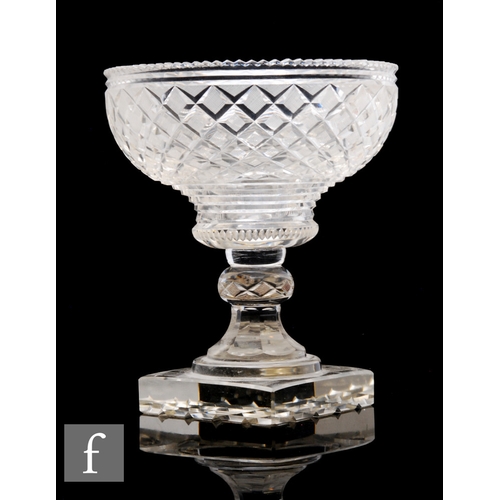 530 - A Georgian clear crystal pedestal bowl with diamond cut decoration above a knopped stem and square f... 