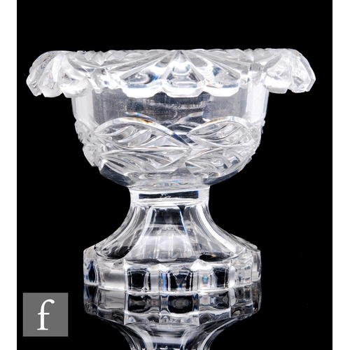 540 - A clear crystal pedestal bowl with roll rim, with mitre cut leaf decoration, raised to a swept facet... 