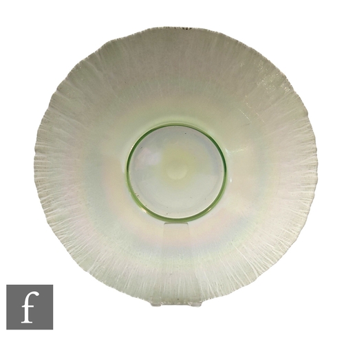 582A - A large 20th Century Uranium 'stretch' glass bowl by Fenton, the circular foot rising to a wide flat... 