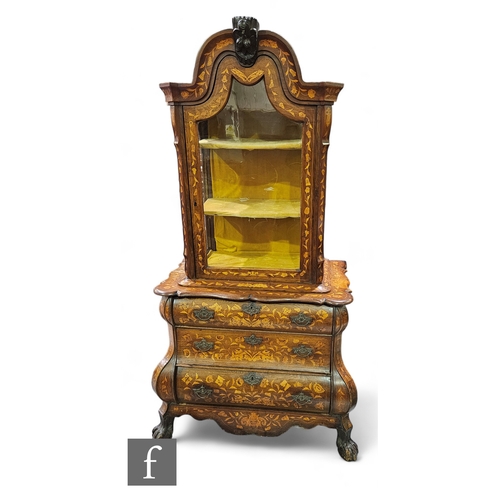 1010 - An 18th Century Dutch bombe marquetry display cabinet, the arched top enclosed by a glazed door belo... 