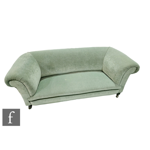 1040 - An Edwardian scroll arm two seater Chesterfield settee on small square mould legs to the front, upho... 