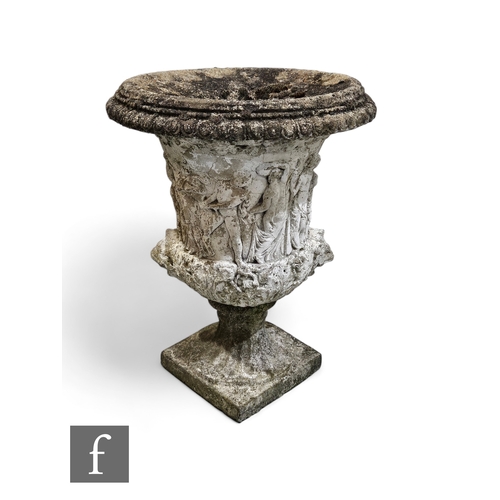 1079 - A small campagna composite stone terrace urn embossed with classical figures on a square base, heigh... 