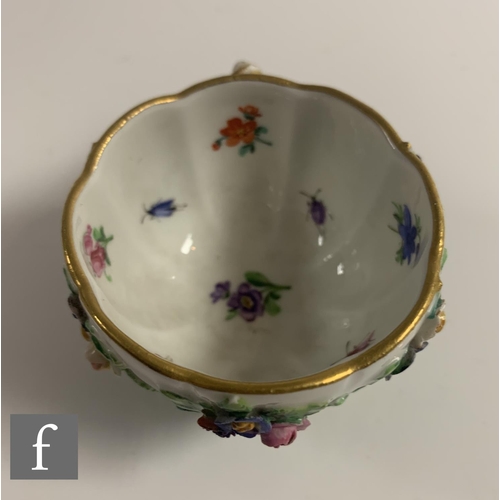 169 - A 19th Century Meissen cabinet cup and saucer, the fluted cup with rustic cross handle and raised to... 