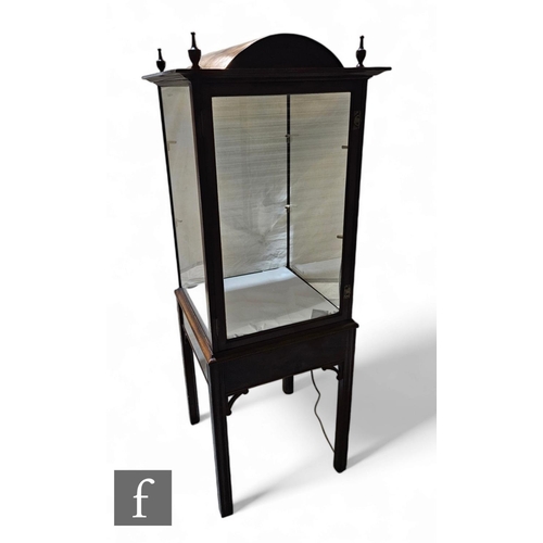 1042 - An Edwardian mahogany floorstanding exhibition style display cabinet, the domed top with four urn sp... 