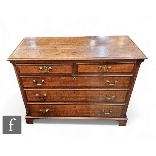 1050 - A 19th Century oak and mahogany crossbanded straight front chest of two short and three long drawers... 