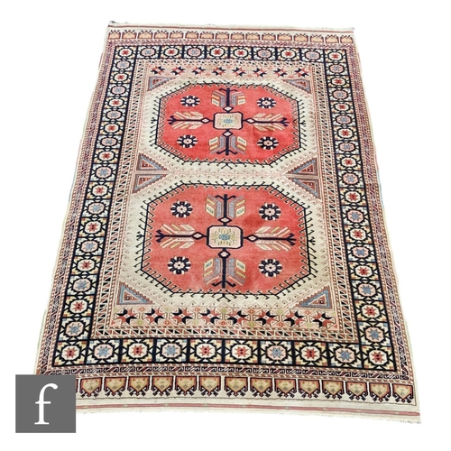 1066 - A Hamadan rug, with a pair of large hooked lozenges on a red and ivory ground border within a pale s... 