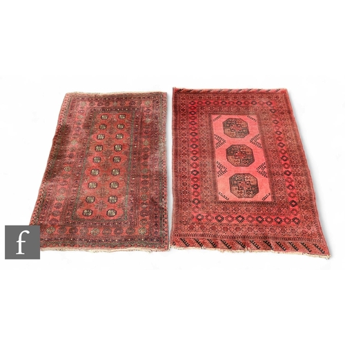 1068 - A Hamadan rug, three central guls on a deep red ground within hooked medallion border, 180cm x 132cm... 