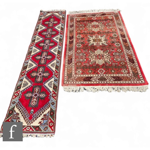 1074 - A Quashqai rug, three central medallions on a red ground within a stylised floral border, 200cm x 14... 