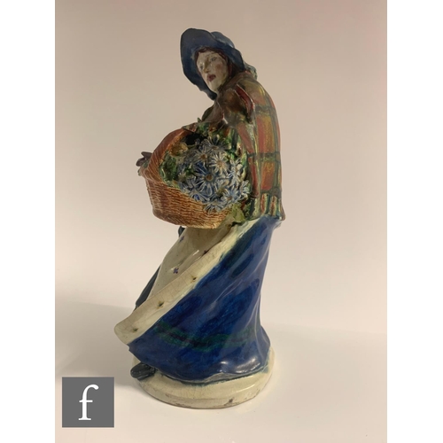 52 - An early 20th Century ceramic figure by Sidney Keats Cope, modelled as a street vendor with bonnet s... 