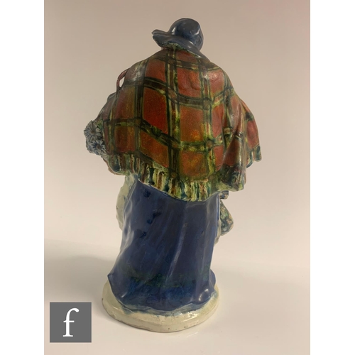 52 - An early 20th Century ceramic figure by Sidney Keats Cope, modelled as a street vendor with bonnet s... 