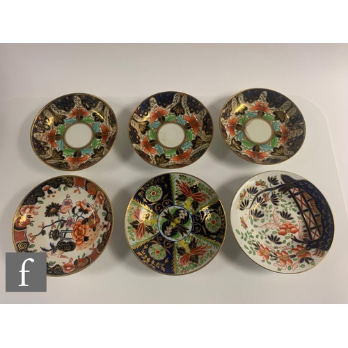 70 - A collection of 19th Century Staffordshire cups and saucers all in variants of the Imari design in a... 