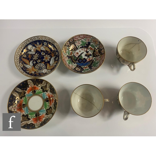 70 - A collection of 19th Century Staffordshire cups and saucers all in variants of the Imari design in a... 