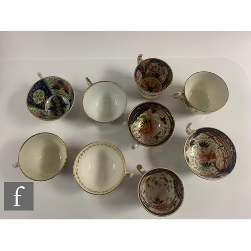 70 - A collection of 19th Century Staffordshire cups and saucers all in variants of the Imari design in a... 