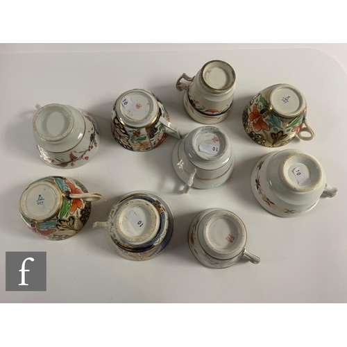 70 - A collection of 19th Century Staffordshire cups and saucers all in variants of the Imari design in a... 