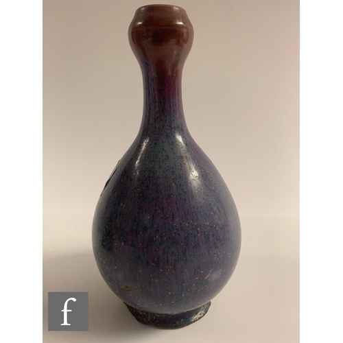 19 - A Chinese Junyao style purple splashed vase, of bottle form rising to a garlic-head rim, height 19cm... 