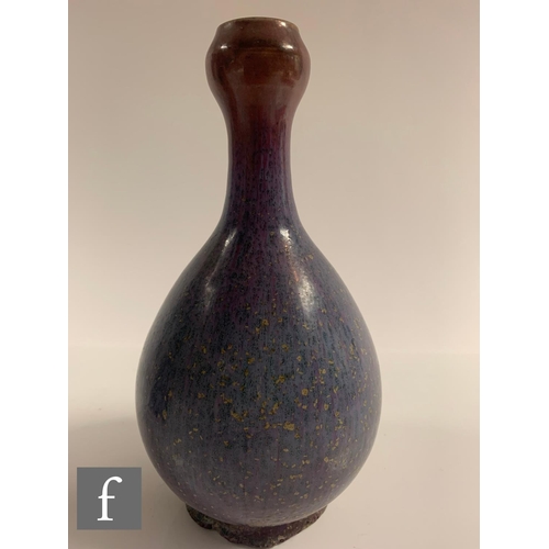 19 - A Chinese Junyao style purple splashed vase, of bottle form rising to a garlic-head rim, height 19cm... 