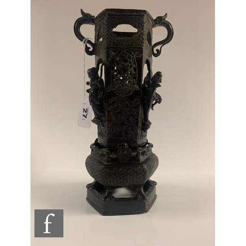 27 - A Chinese late Qing Dynasty cast metal censer, raised on a hexagonal base with pierced sides adorned... 