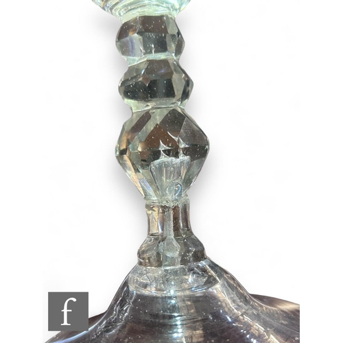 506 - A 19th Century clear crystal drinking glass, the round funnel bowl above a multi knopped facet stem ... 