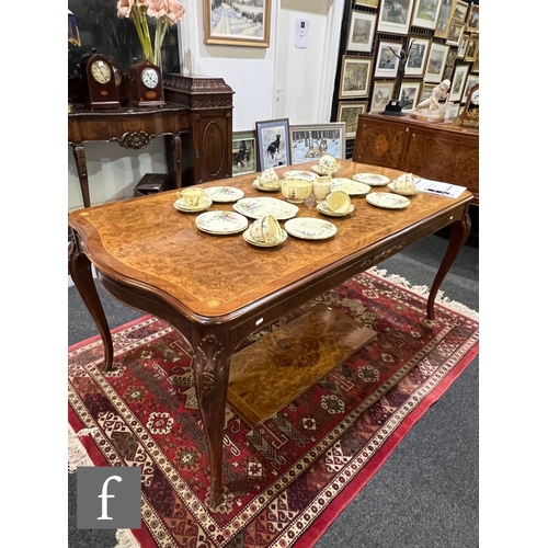 1002 - A 20th Century Italian figured walnut dining room suite, comprising a serpentine front sideboard on ... 