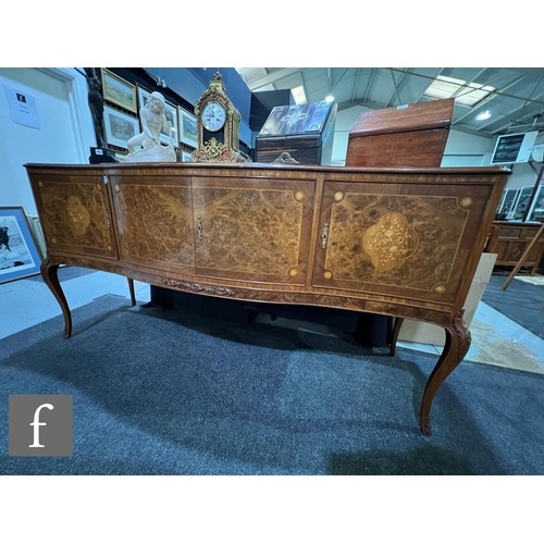 1002 - A 20th Century Italian figured walnut dining room suite, comprising a serpentine front sideboard on ... 