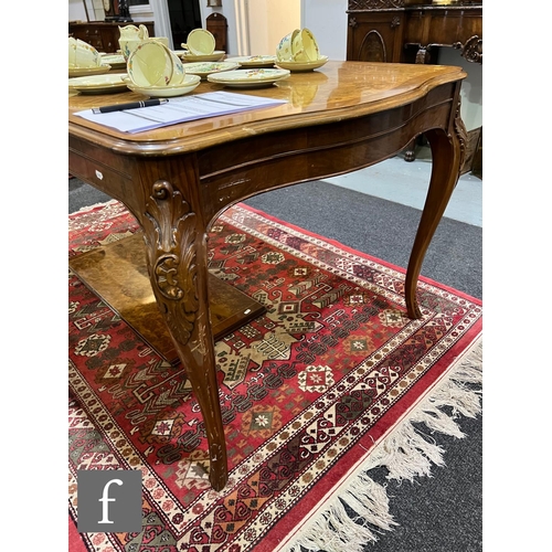 1002 - A 20th Century Italian figured walnut dining room suite, comprising a serpentine front sideboard on ... 