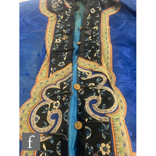 16 - A Chinese late Qing Dynasty embroidered silk short jacket, the blue ground, edged with embroidered r... 