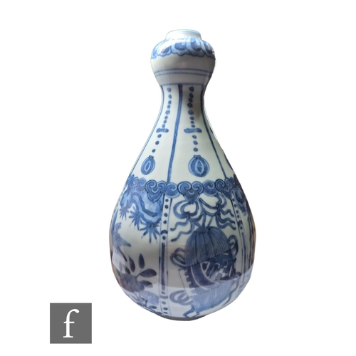 11 - A Chinese Wanli style blue and white garlic head vase, decorated with segmented panel, filled with b... 