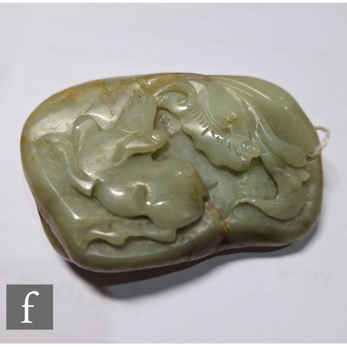 14 - A Chinese Qing Dynasty jade pebble carving, the smooth pale green and russet stone, carved in relief... 