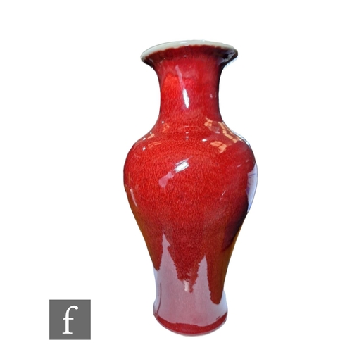 18 - A Chinese Kangxi style Sang-de-boeuf vase, of meiping form, the body with all over rich red glaze, K... 