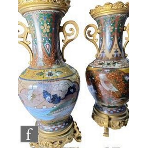 29 - A pair of Chinese cloisonne vases of ovoid form, rising to a flared neck, decorated with ochre, aven... 