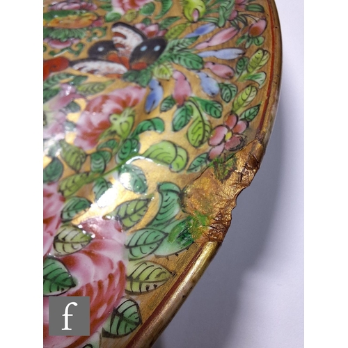 321 - A 19th Century Cantonese famille rose patterned plate, centred with a white vase and decorated with ... 