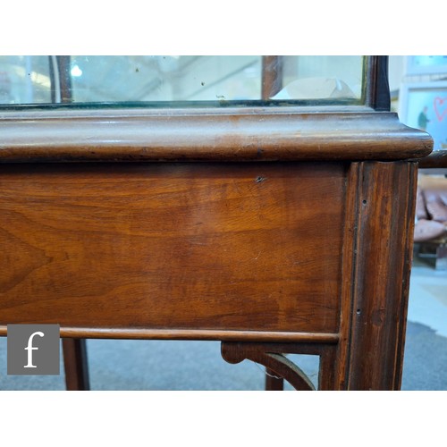 1042 - An Edwardian mahogany floorstanding exhibition style display cabinet, the domed top with four urn sp... 