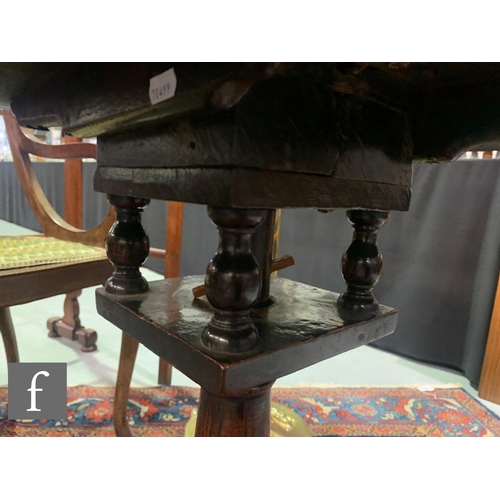 1007 - A George III oak circular tripod occasional table with a bird cage movement and an Art Nouveau coppe... 