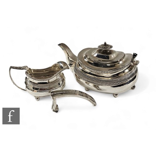 264 - A hallmarked silver boat shaped teapot and a matched cream jug, total weight 25oz, London 1814 and 1... 