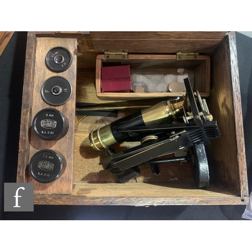 832 - An early 20th Century Beck microscope, No 40134, part brass and black painted, with lens and accesso... 