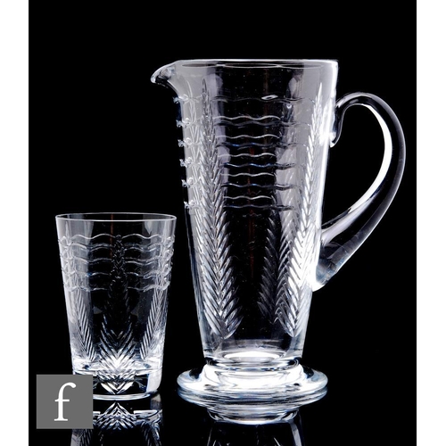 587 - A 20th Century Webb Corbett glass jug of footed form with applied loop handle, cut with stylised lea... 