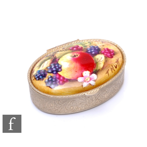 290 - A contemporary oval pill box inset with a hand painted oval tablet depicting a fallen fruits scene w... 