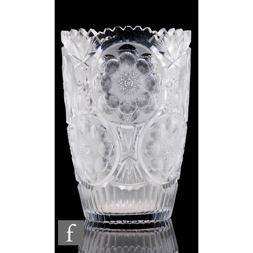 346 - A large continental clear crystal glass vase of tumbler form decorated with repeat circular panels o... 