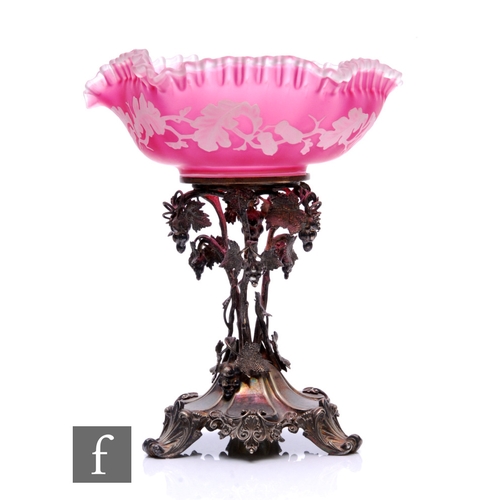 A late 19th Century Stourbridge cameo glass table centre bowl, the bowl cased in opal over ruby with a tight frill rim and cut with oak boughs with acorns, raised to an ornate silver plated stand.