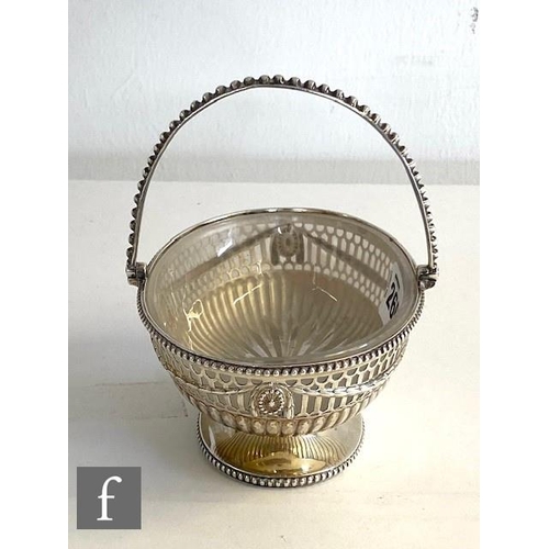 260 - A Georgian hallmarked silver small oval pedestal swing basket, with pierced and swag decoration with... 