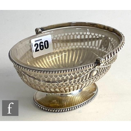 260 - A Georgian hallmarked silver small oval pedestal swing basket, with pierced and swag decoration with... 