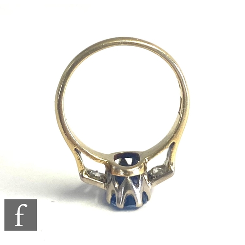 72 - An 18ct hallmarked sapphire and diamond three stone ring, central oval cornflower blue sapphire flan... 