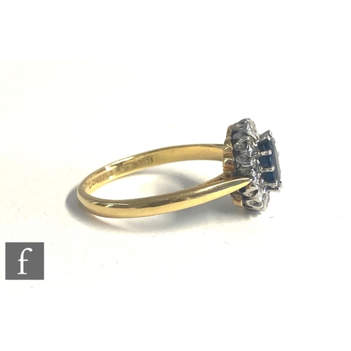 85 - An 18ct hallmarked sapphire and diamond cluster ring, central oval sapphire within a border of ten d... 