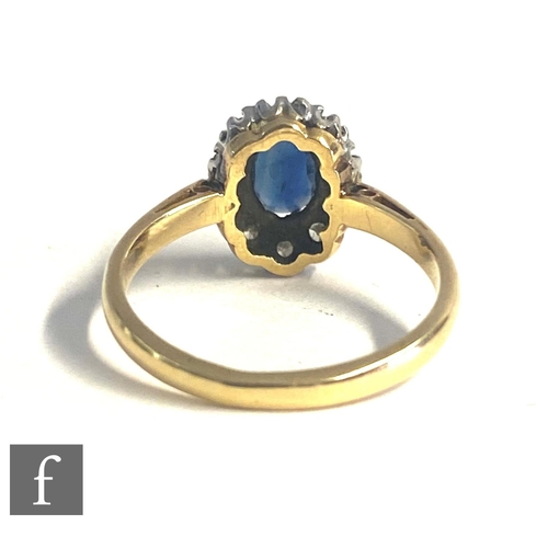 85 - An 18ct hallmarked sapphire and diamond cluster ring, central oval sapphire within a border of ten d... 